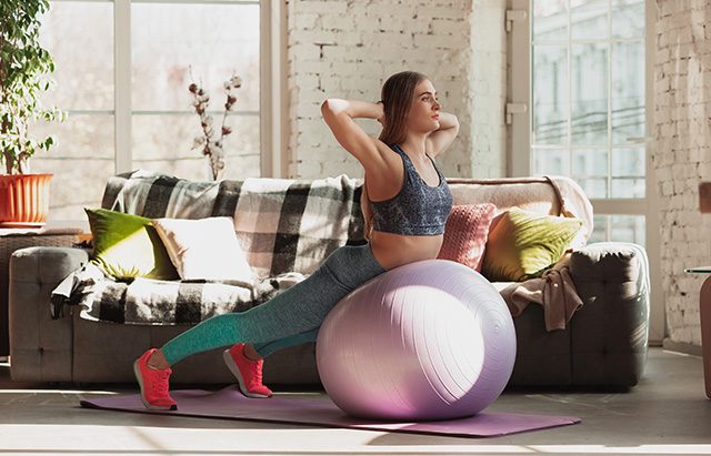 young-woman-teaching-at-home-online-courses-of-fitness-aerobic-sporty-lifestyle-while-quarantine-getting-active-while-isolated-wellness-movement-concept-exercises-with-fitball-for-lower-body young-woman-teaching-at-home-online-courses-of-fitness-aerobic-sporty-lifestyle-while-quarantine-getting-active-while-isolated-wellness-movement-concept-exercises-with-fitball-for-lower-body